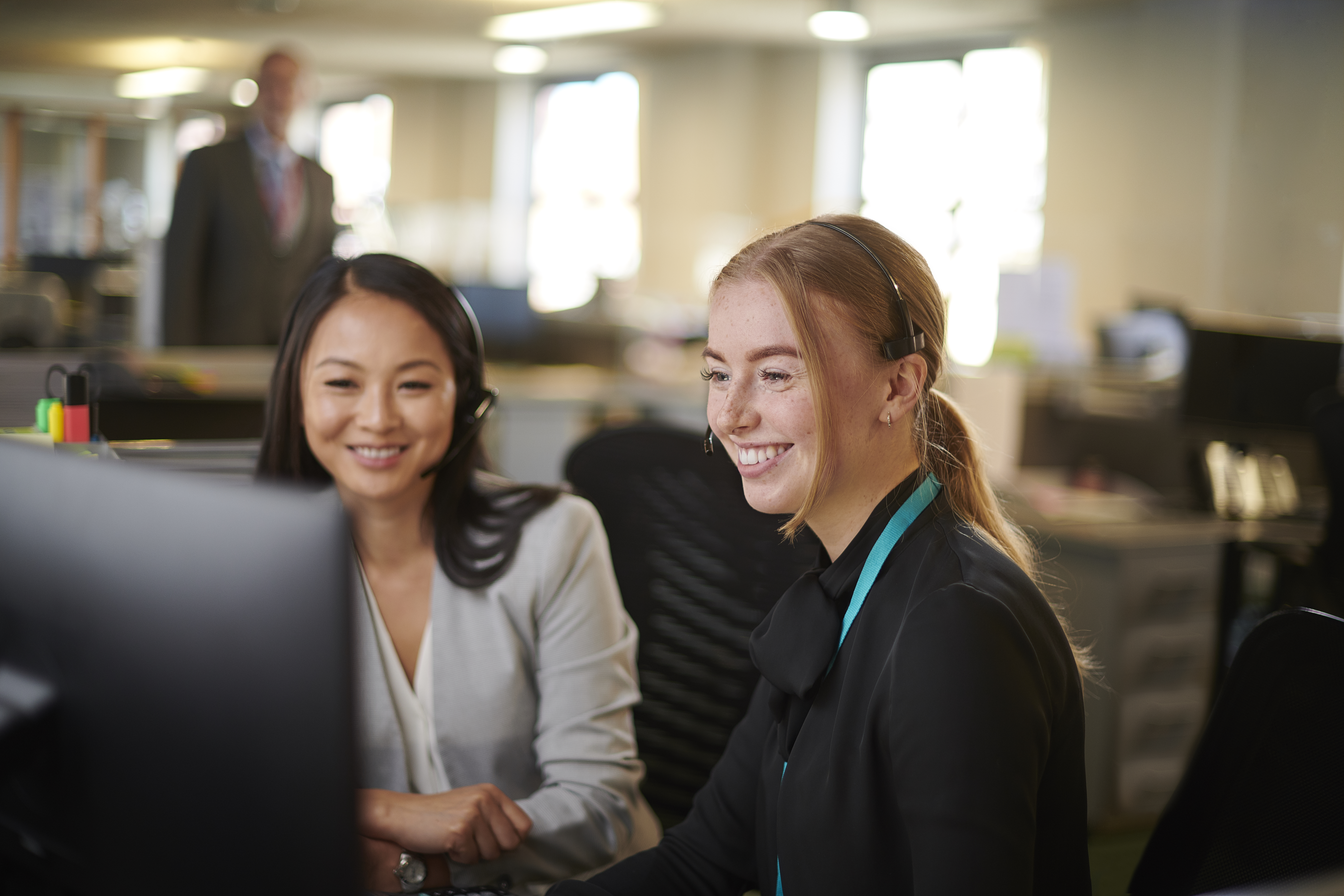2 women sitting at a computer