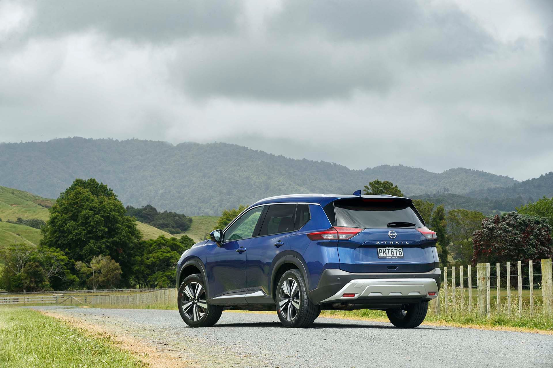 Blue Nissan X Trail static shot from the rear.