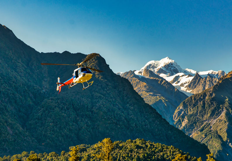 Search and rescue helicopter flying in the mountains in New Zealand.