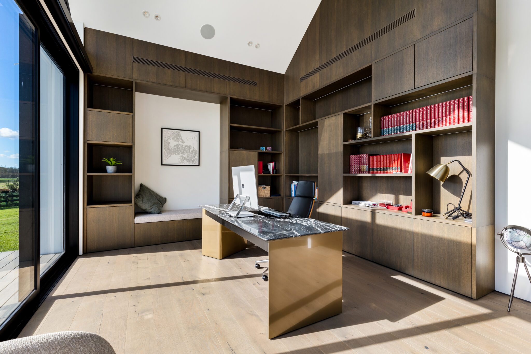 Home office by Henry Lin featuring ample storage, connection to nature, and task-oriented furniture for an ideal workspace.