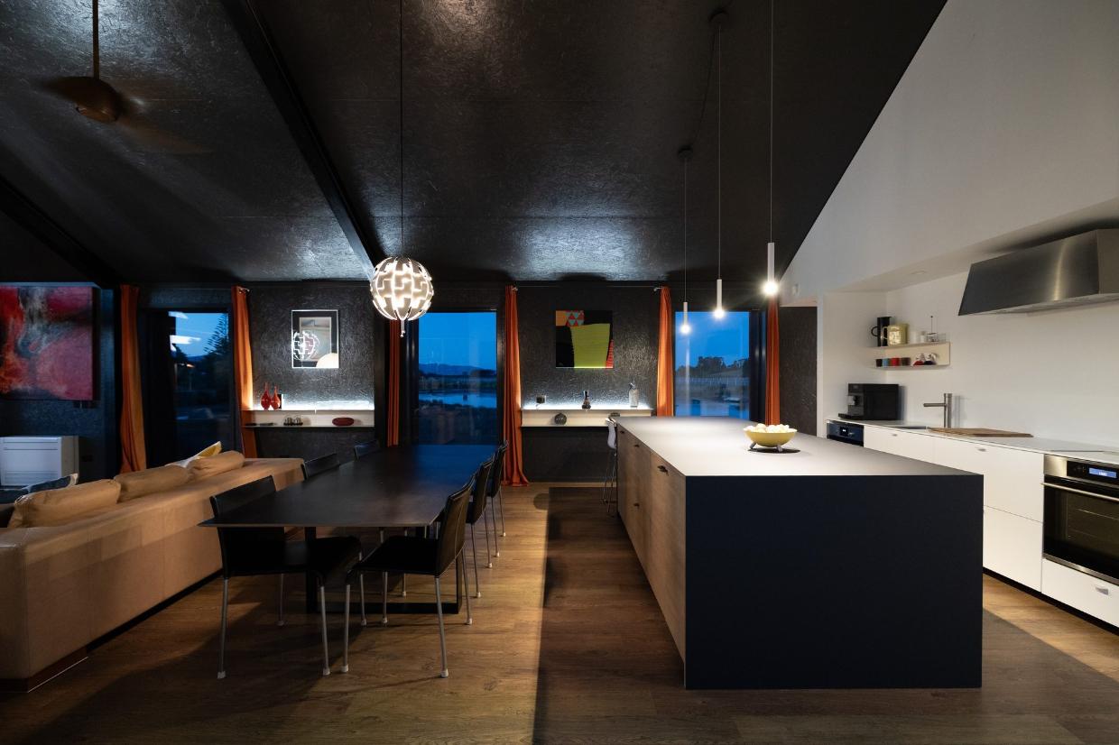 Moody at night: The open-plan layout ensures the house is ideal for entertaining. 