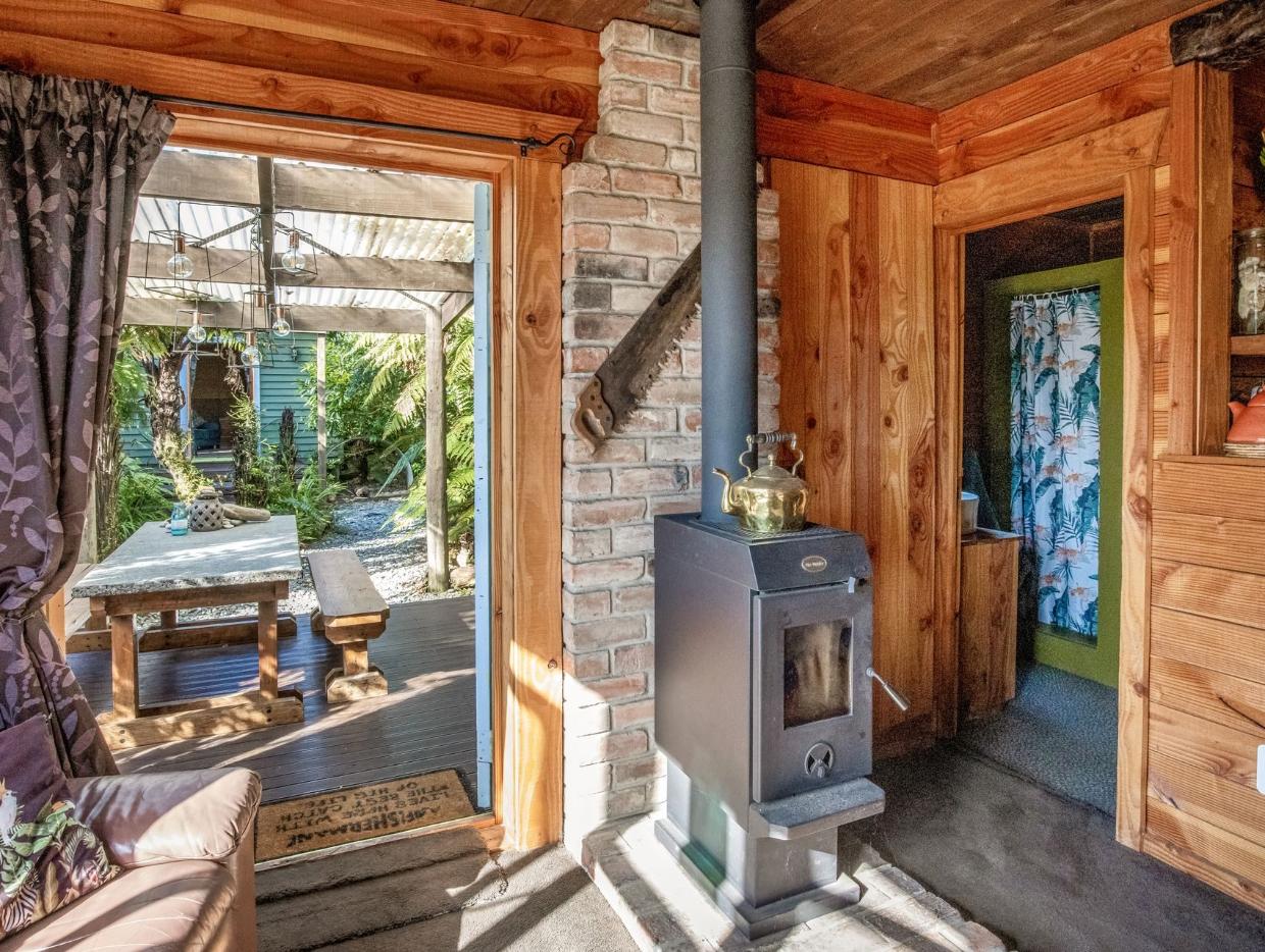 There's a covered outdoor dining area off the living room.