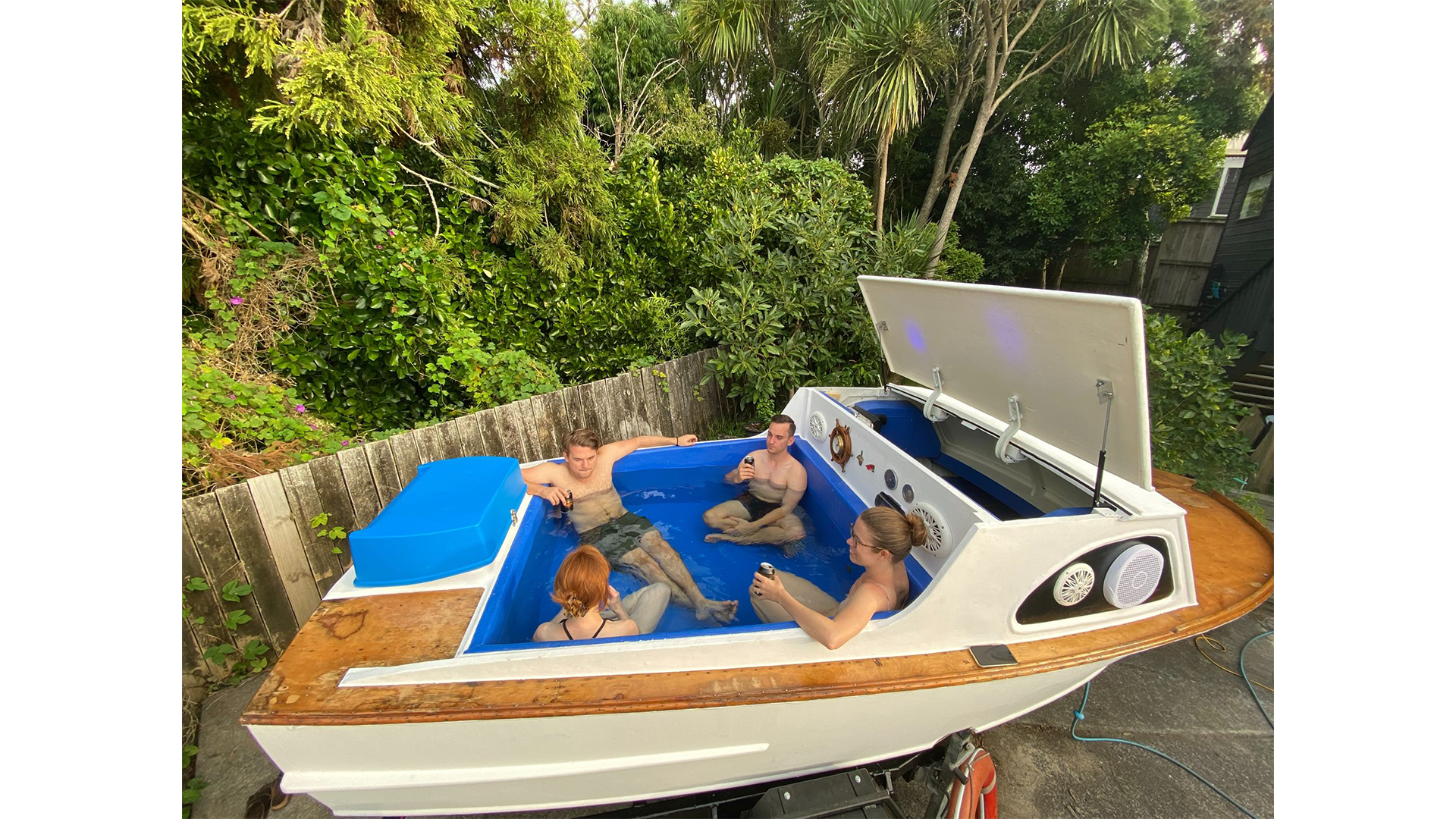 Creative 'spoat' spa crafted from a salvaged boat, featuring lights and a sound system.