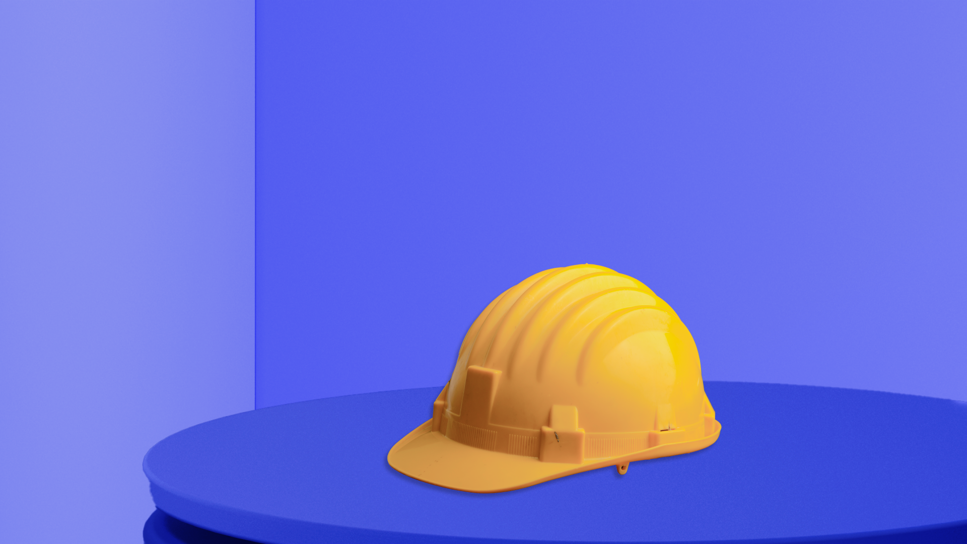 An image of a yellow hard hard on a blue background