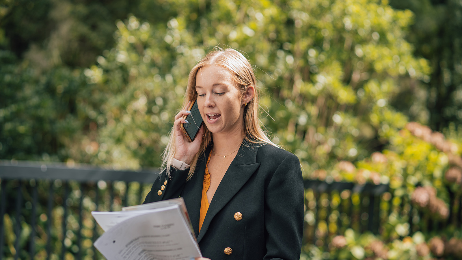 Self employed woman on the phone to the bank asking about a mortgage.