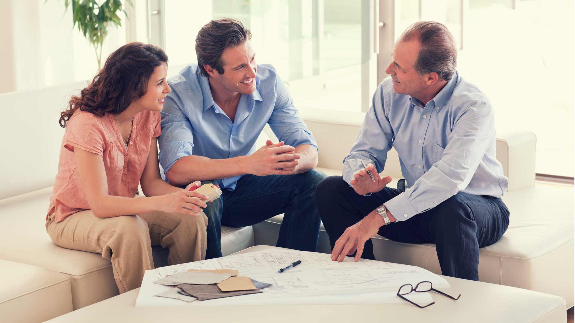 A couple talking to property developers in New Zealand