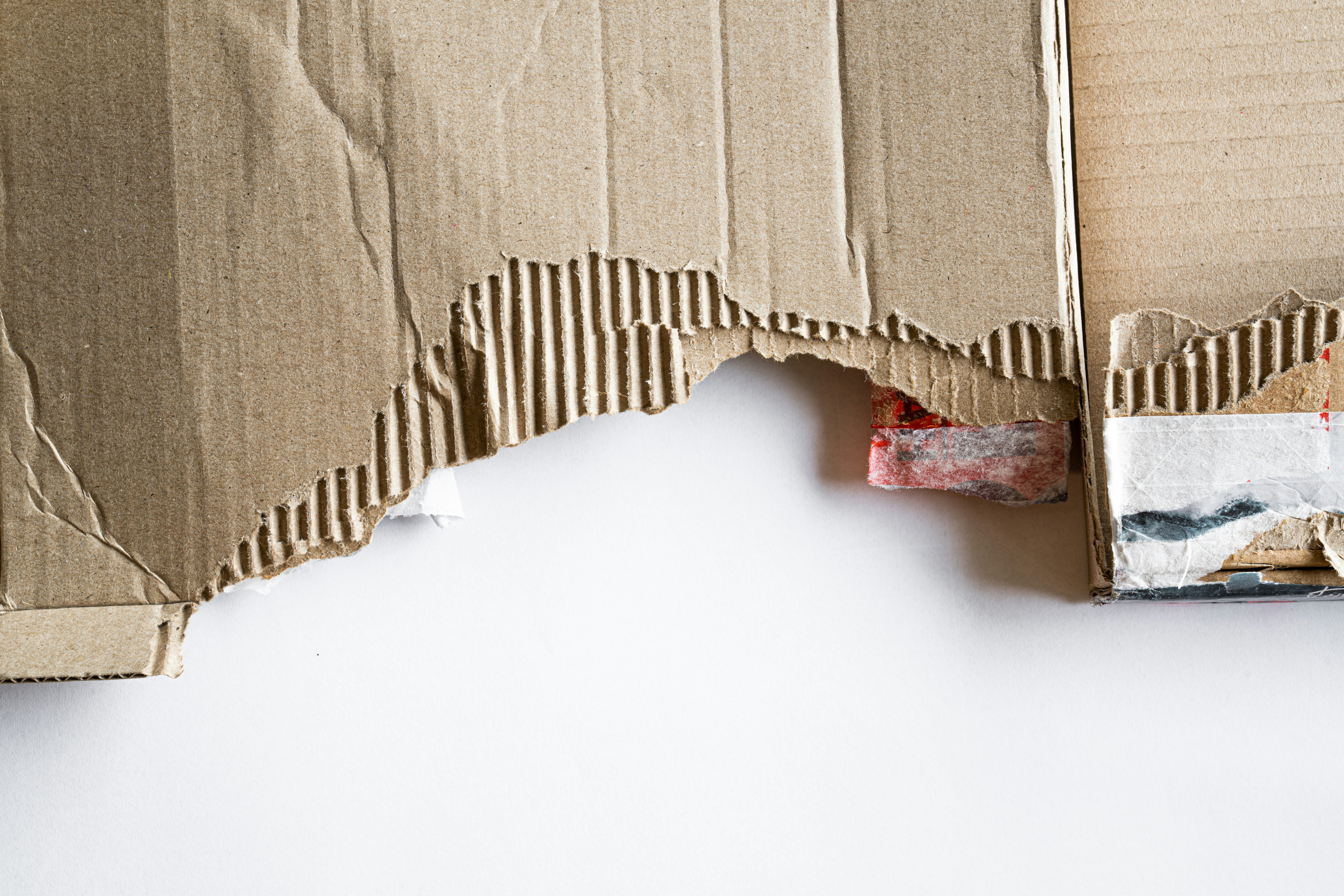 A cardboard box with exterior damage.