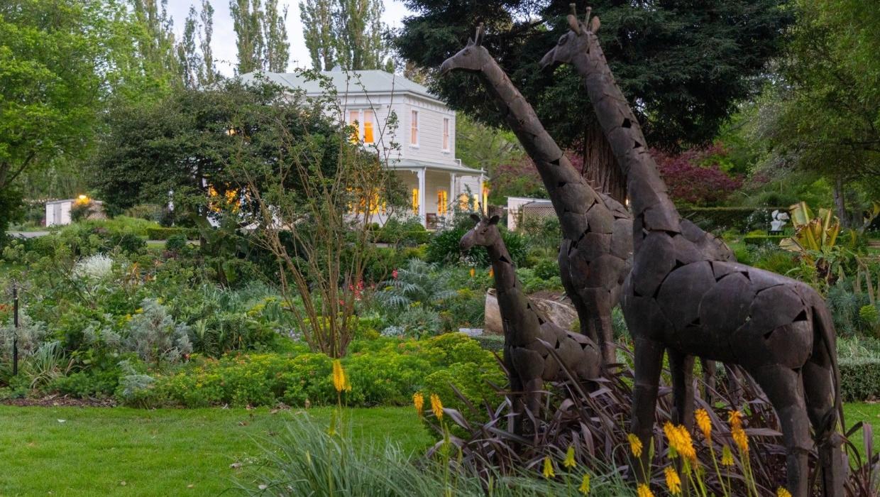 The garden with three giraffes brought back from Africa.