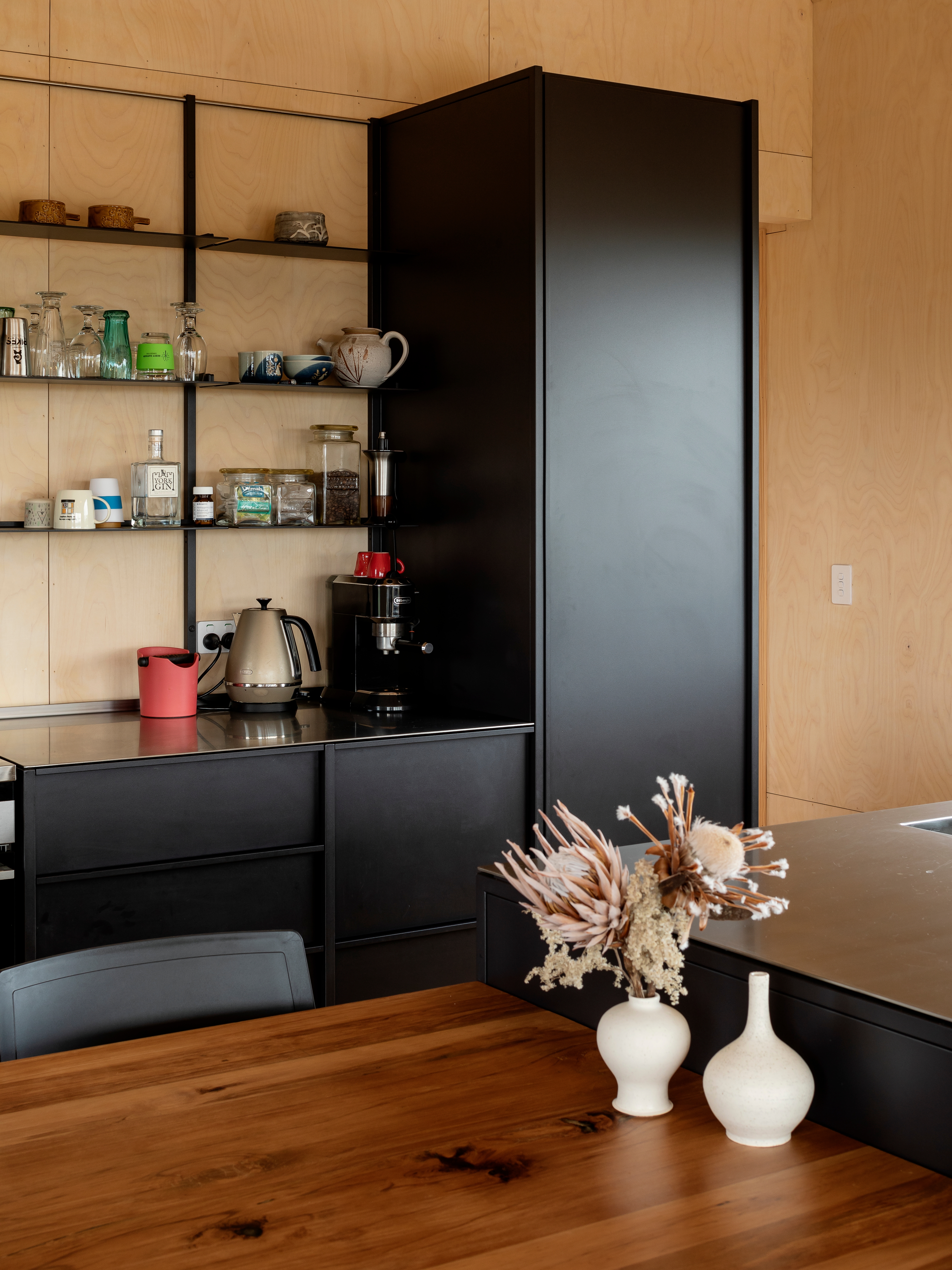 The kitchen’s open shelves make life easy, says Sarah. Frequently used crockery is kept on them, so there’s no chance for dust to settle. Like the bench, the powdercoated black cabinetry by IMO is also stainless steel; both are hardy enough to last a lifetime.