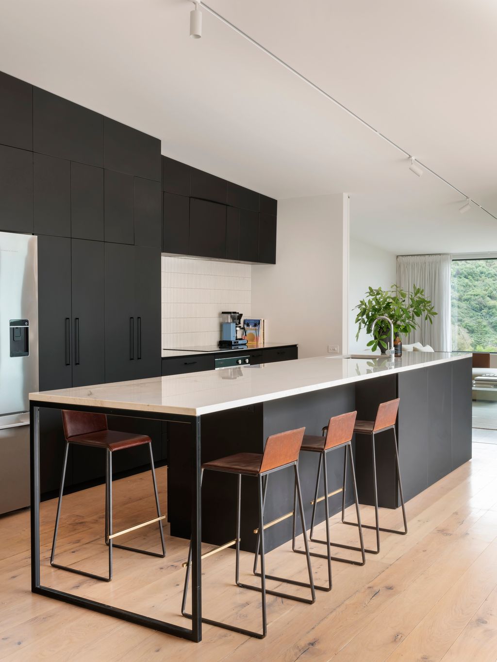 Open kitchen flowing to living space and deck.