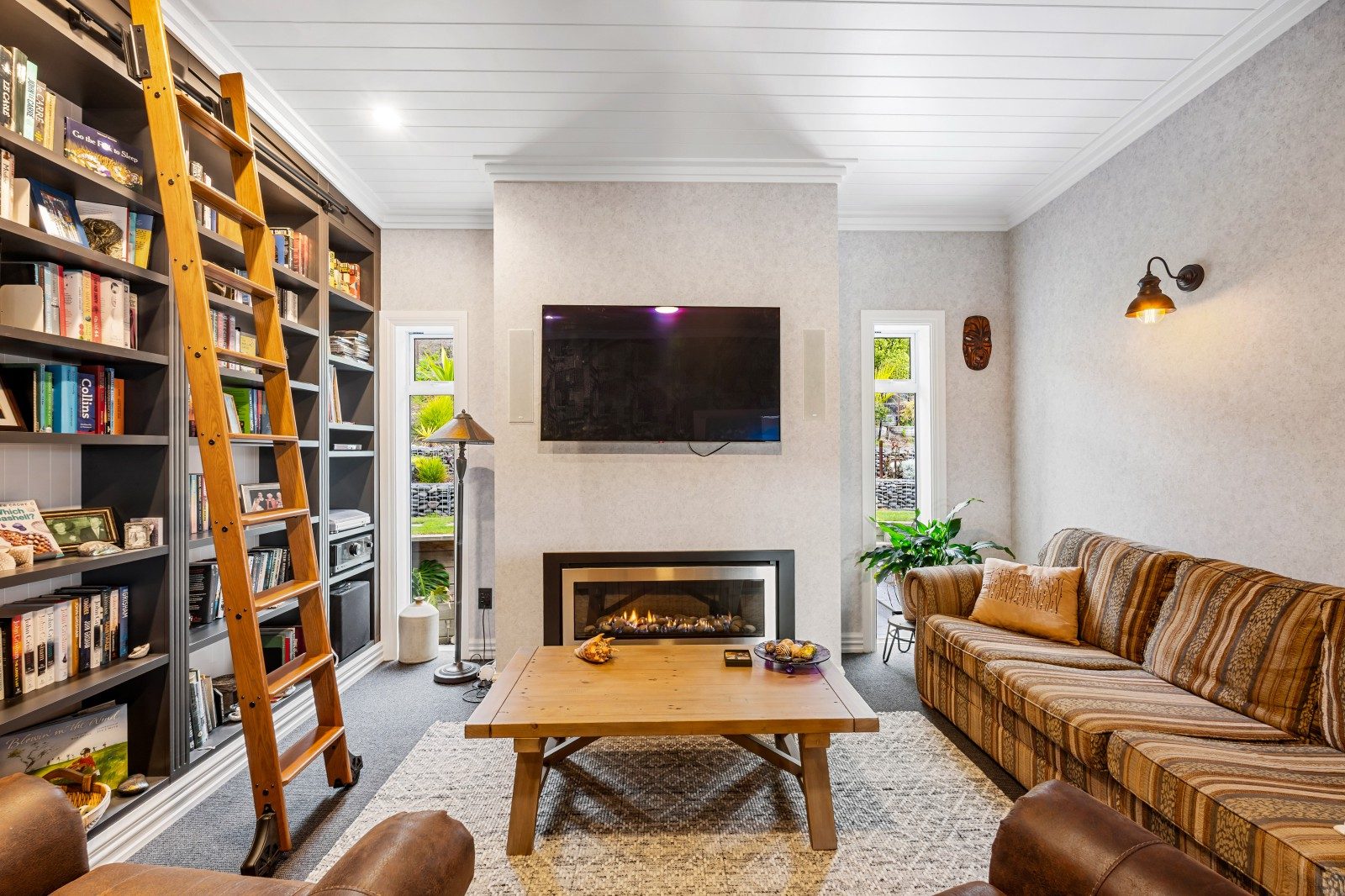 fire side in the library at Mahia beach home