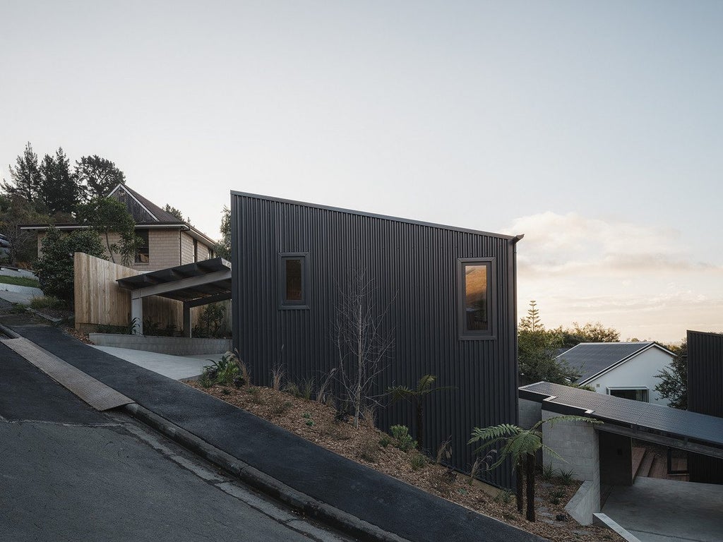 New home exterior shown with dark design.