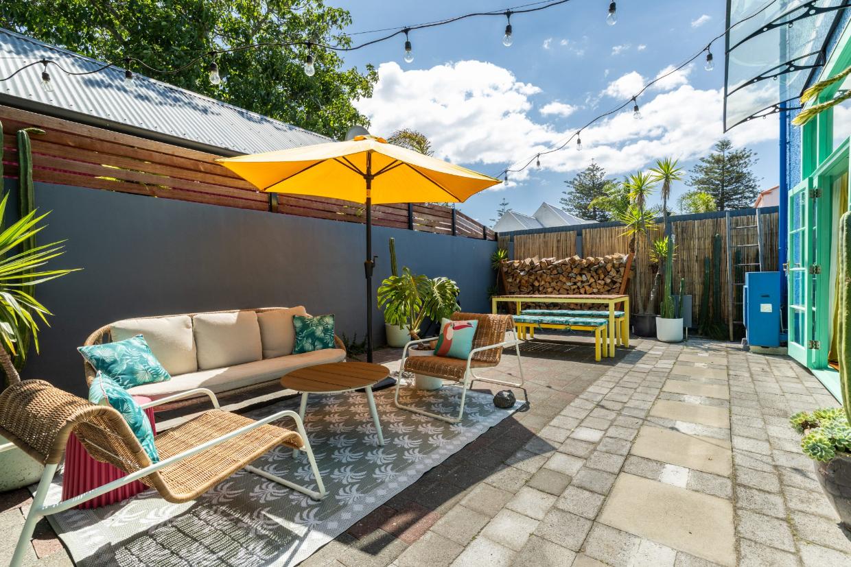 The living area opens directly onto the expansive sunny courtyard.