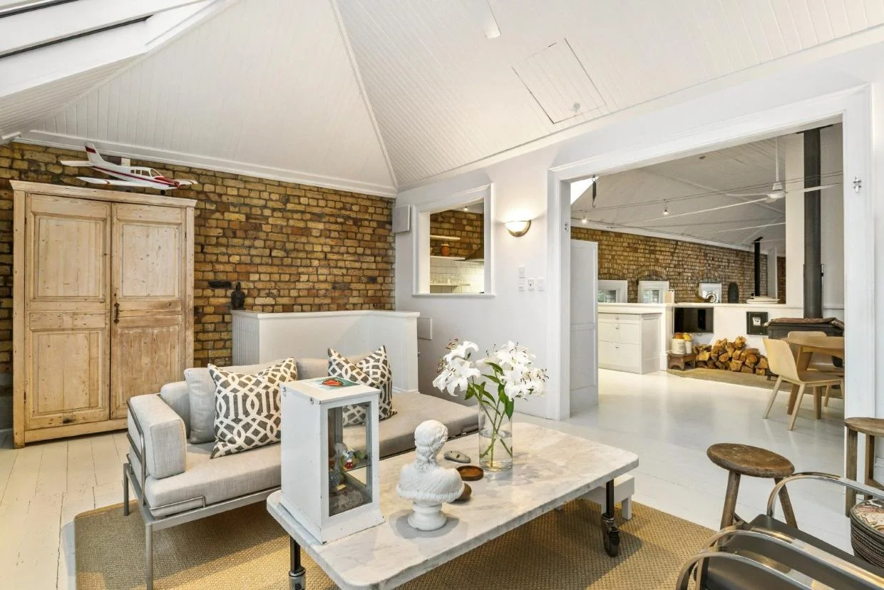 The space is open to a casual dining area and kitchen.