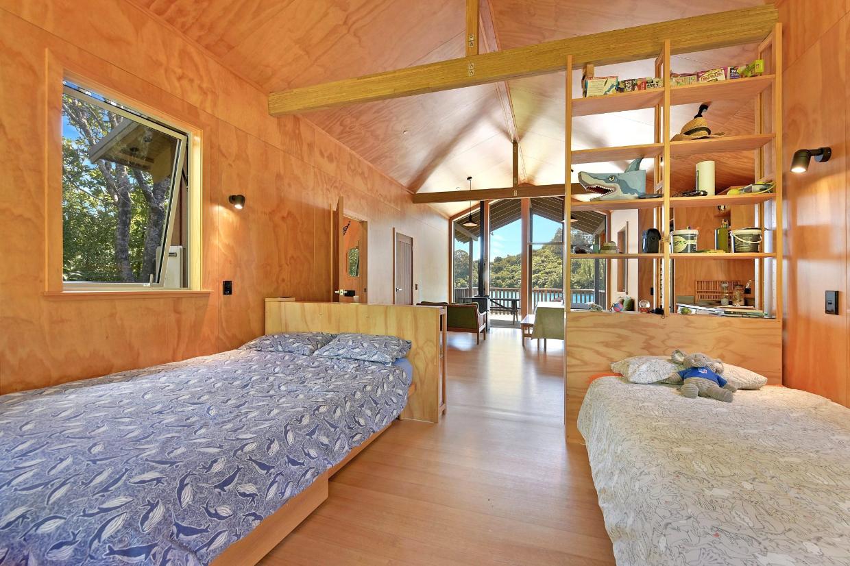 Twin beds maximise the space and allow a circulation route to the outdoors.