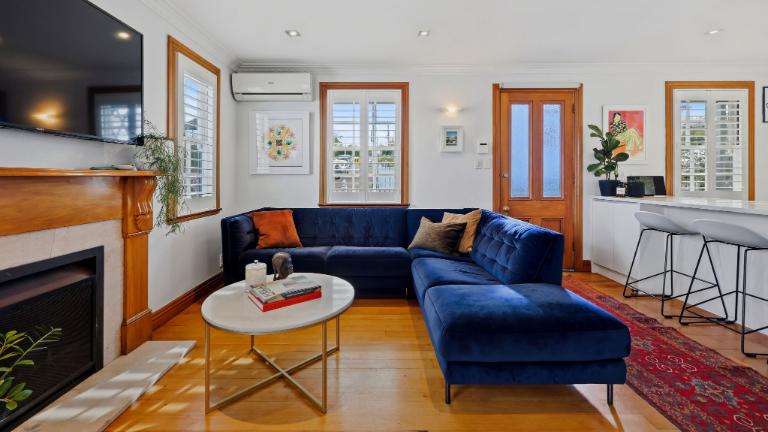 The lower level is a spacious open-plan space with a large woodburner that “heats the whole house in five minutes”. Photo: Ray White