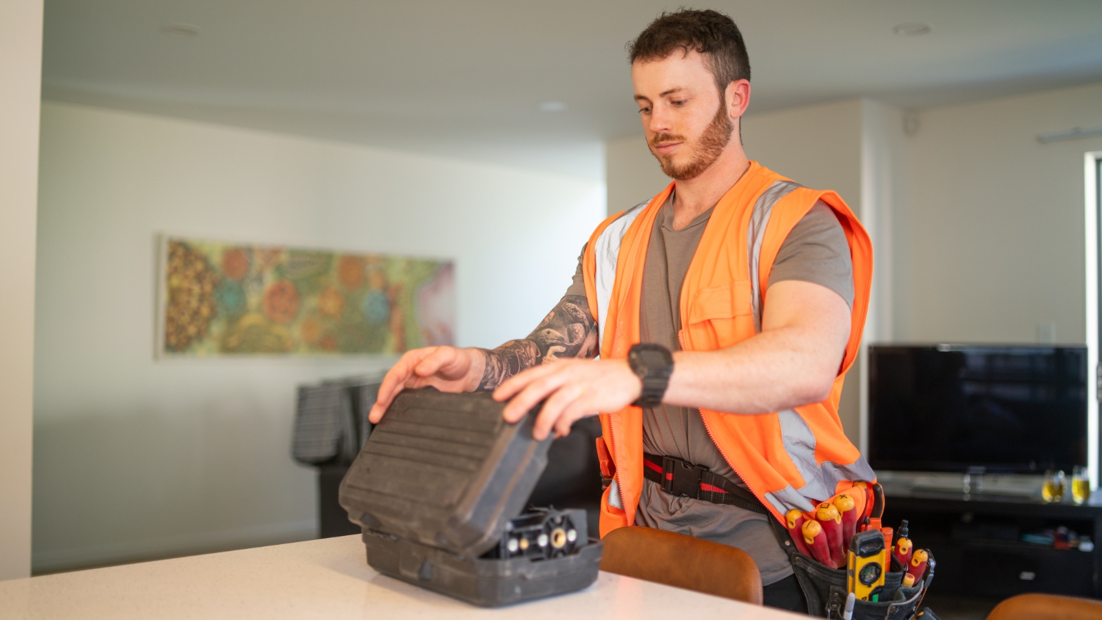 Male plumber looking at tools. 