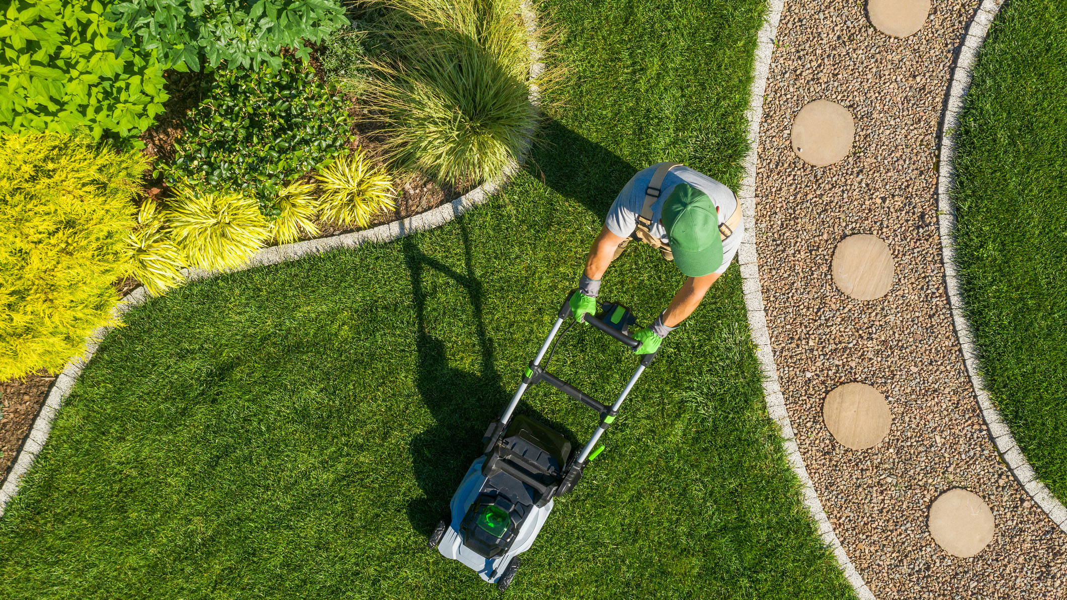 Man mowing the lawn to earn some extra cash.