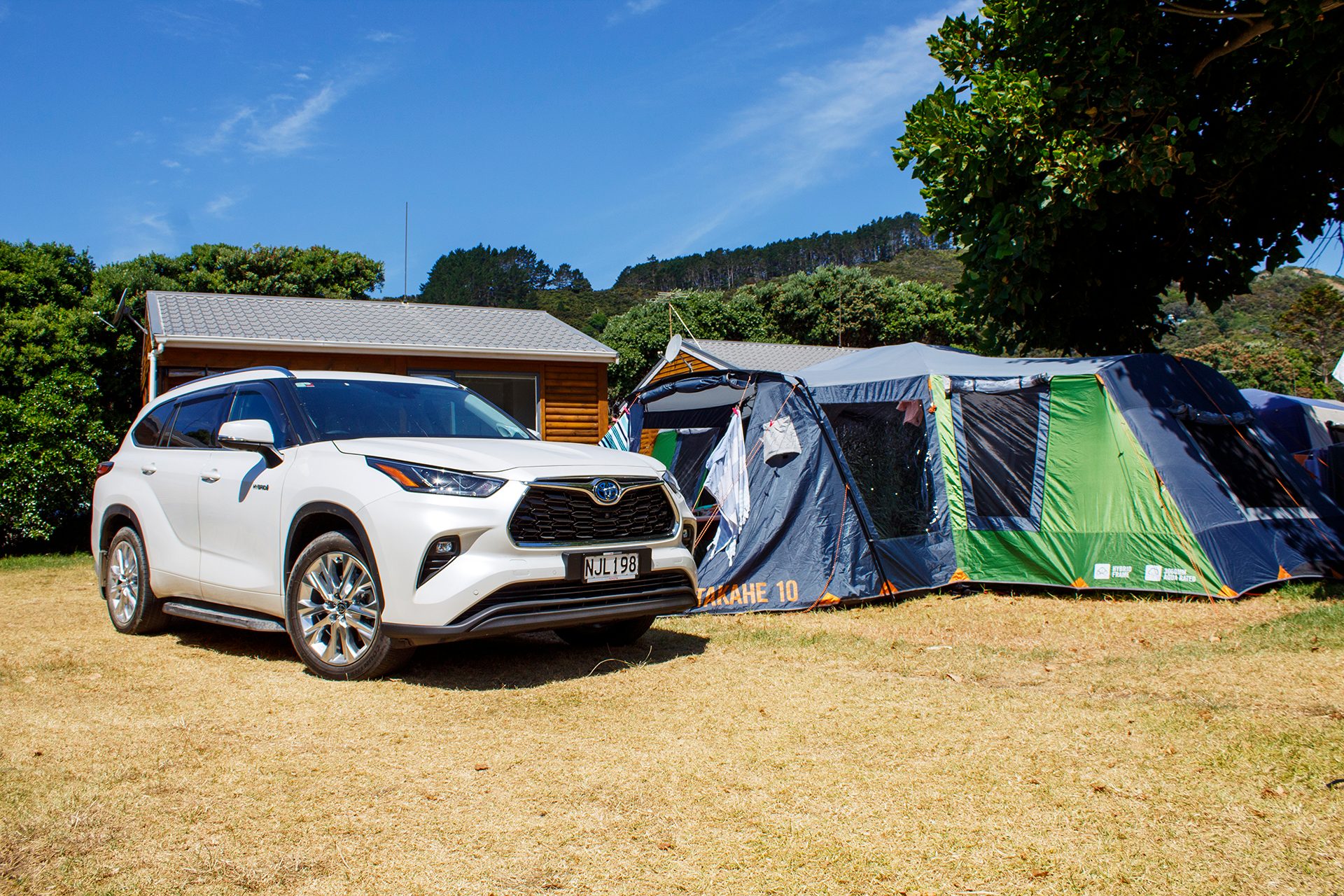 White Toyota Highlander parked by campsite