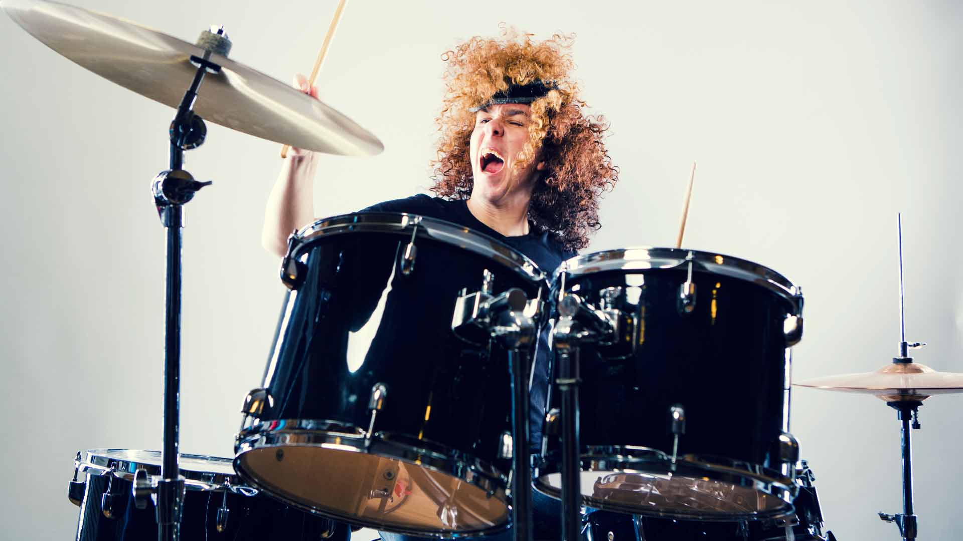 Young man playing drums.