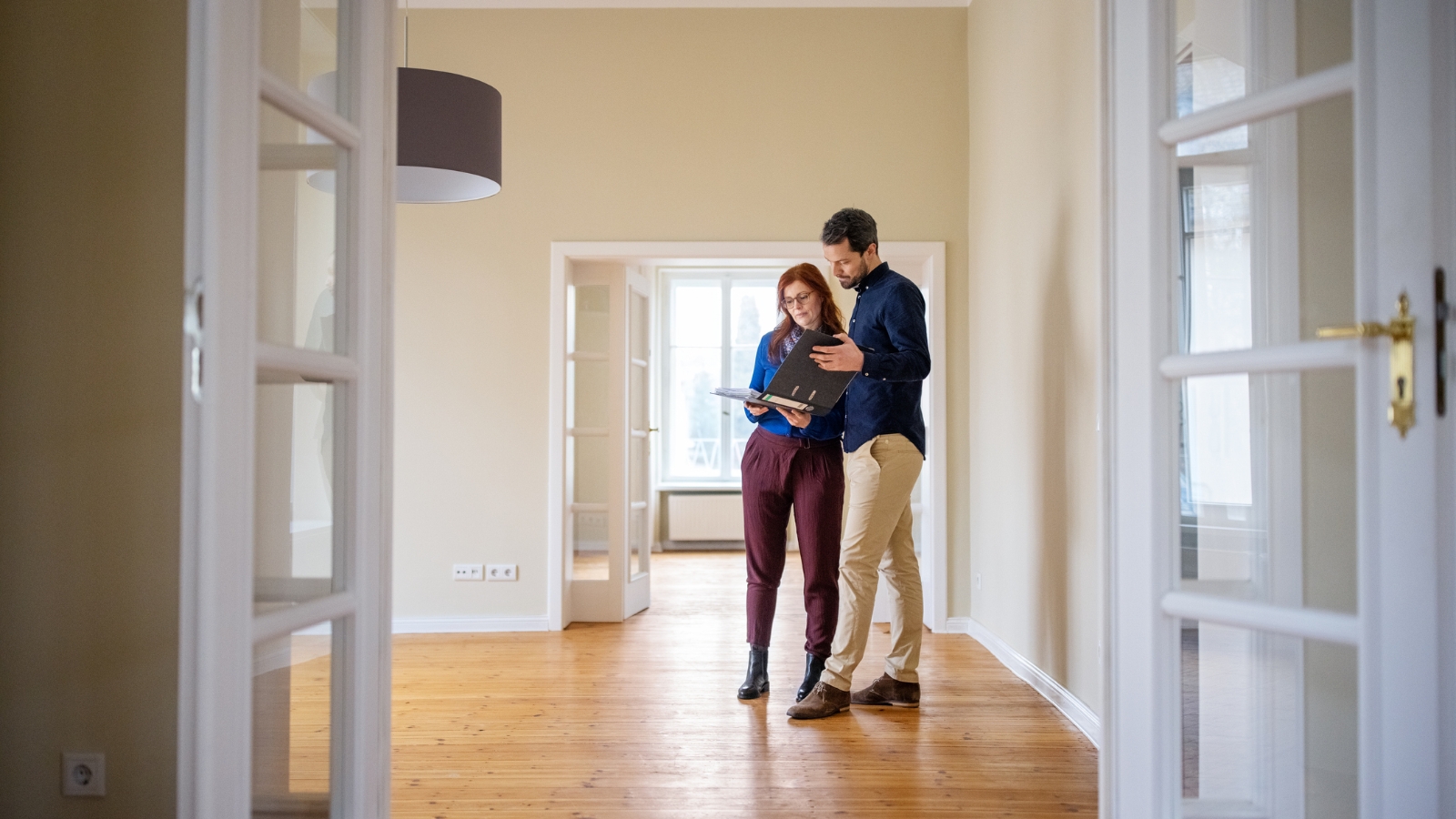 Two buyers talking to real estate agent. 