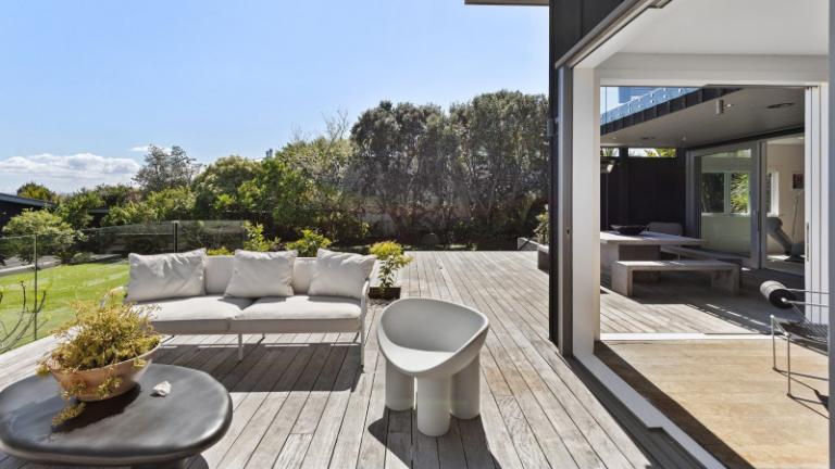 A large entertaining terrace that steps down to the lawn is used all year round. Photo: NZ Sotheby's