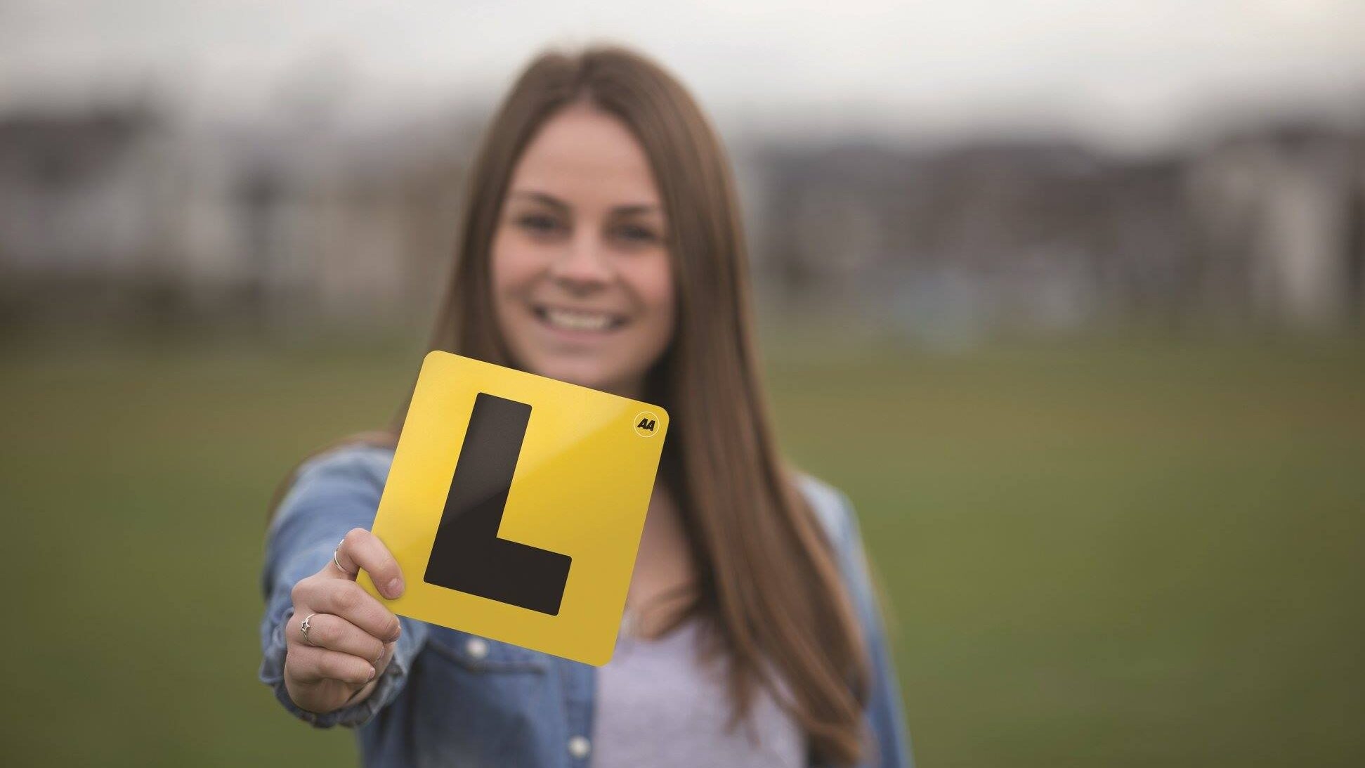 Close up picture of someone holding learner plates