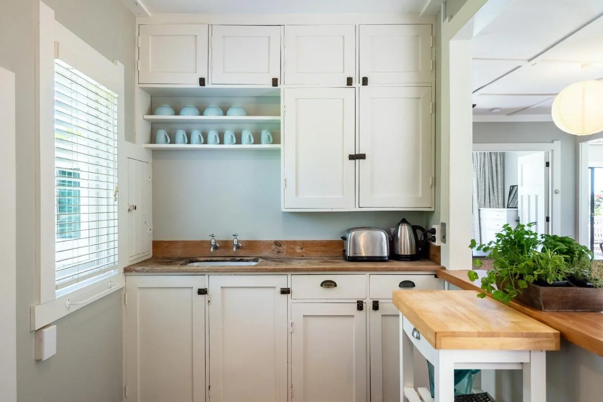 The kitchen is near-original. To the left of the wooden benchtop is the safe, a cupboard that pops out on the shady side of the house where food was kept chilled.