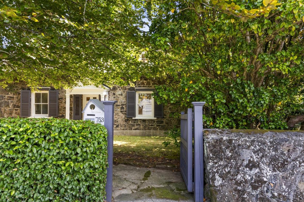 The house is beautifully set among mature trees and lush gardens, giving it plenty of character and privacy