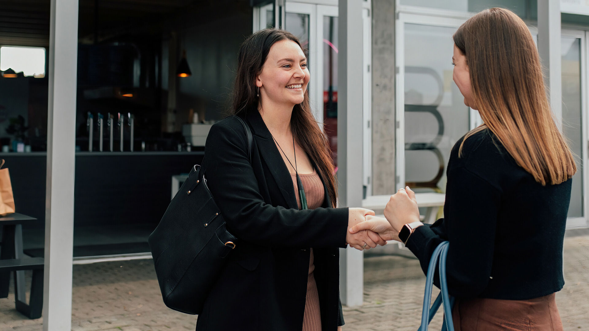 Female employee shaking hands with her boss as she leaves her job.