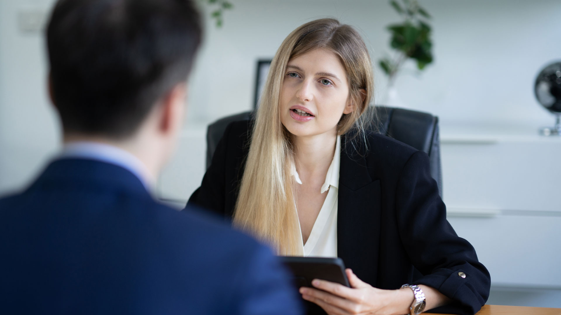 A client having a difficult conversation with his real estate agent in her office.