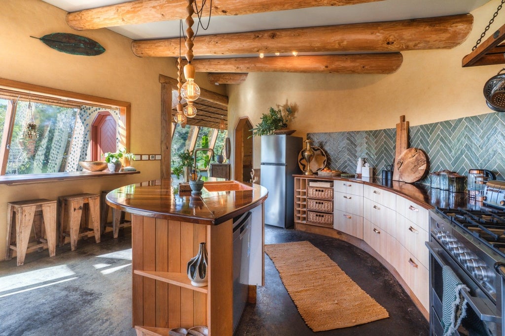 Timber surfaces complement the earth brick walls. Photo: Pete May