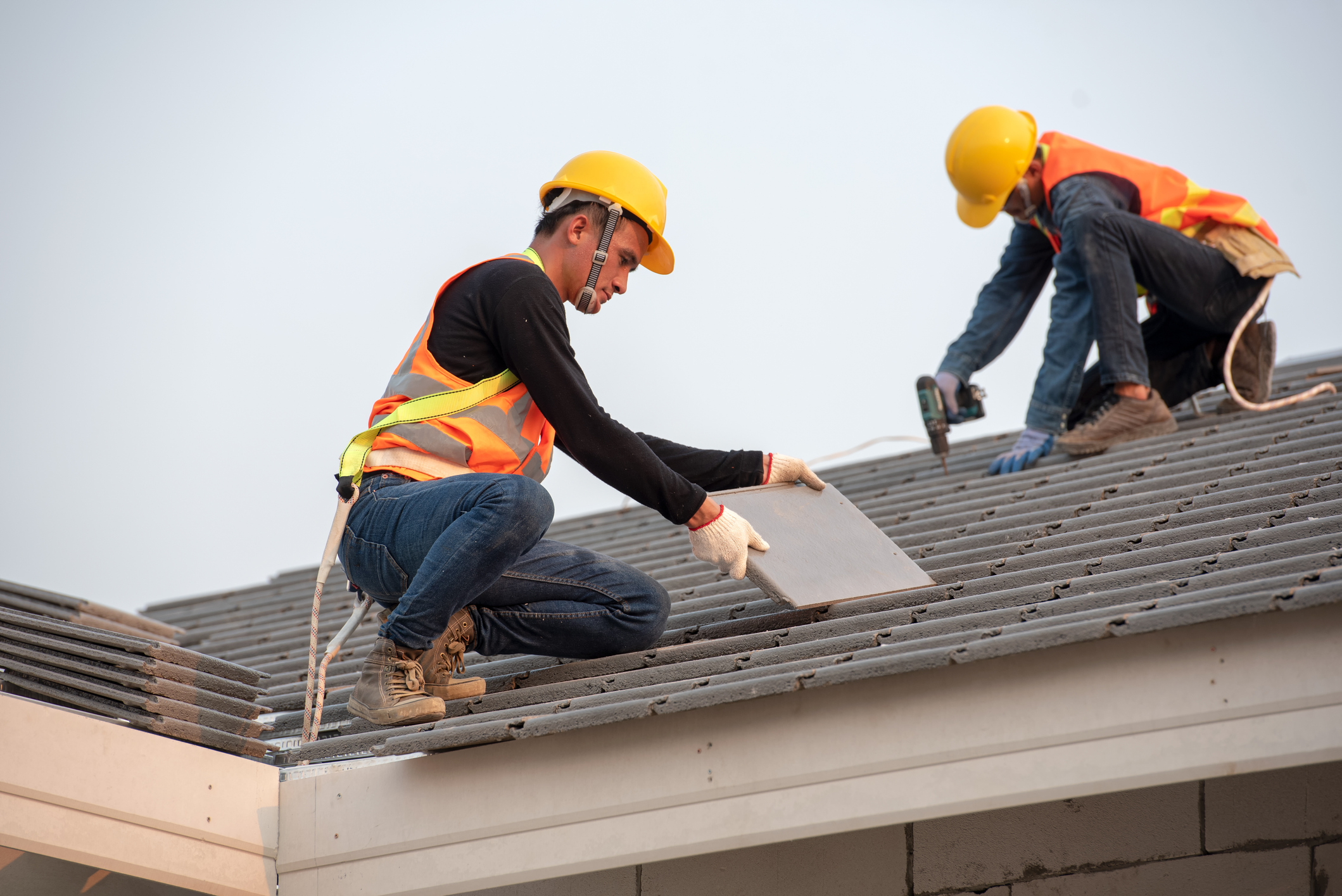 Two men working together on a roof