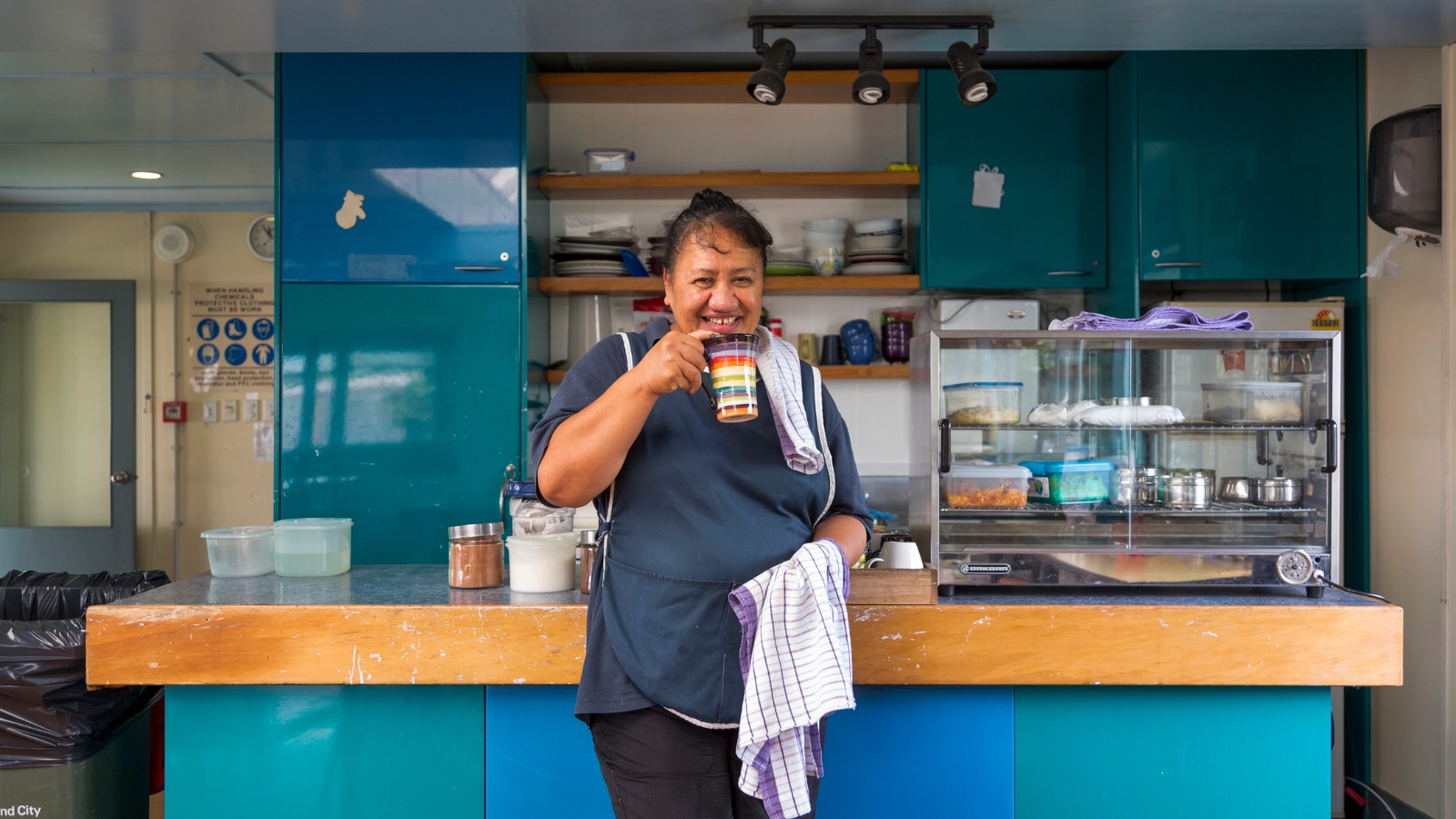 Lunch lady at hospital holding tea. 