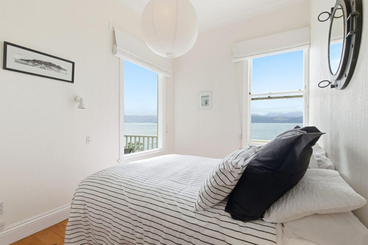 Bedroom has multiple windows displaying the views and sunshine. 