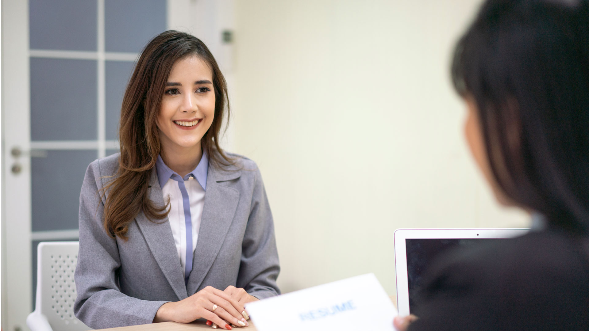 Interviewee smiling in a job interview.