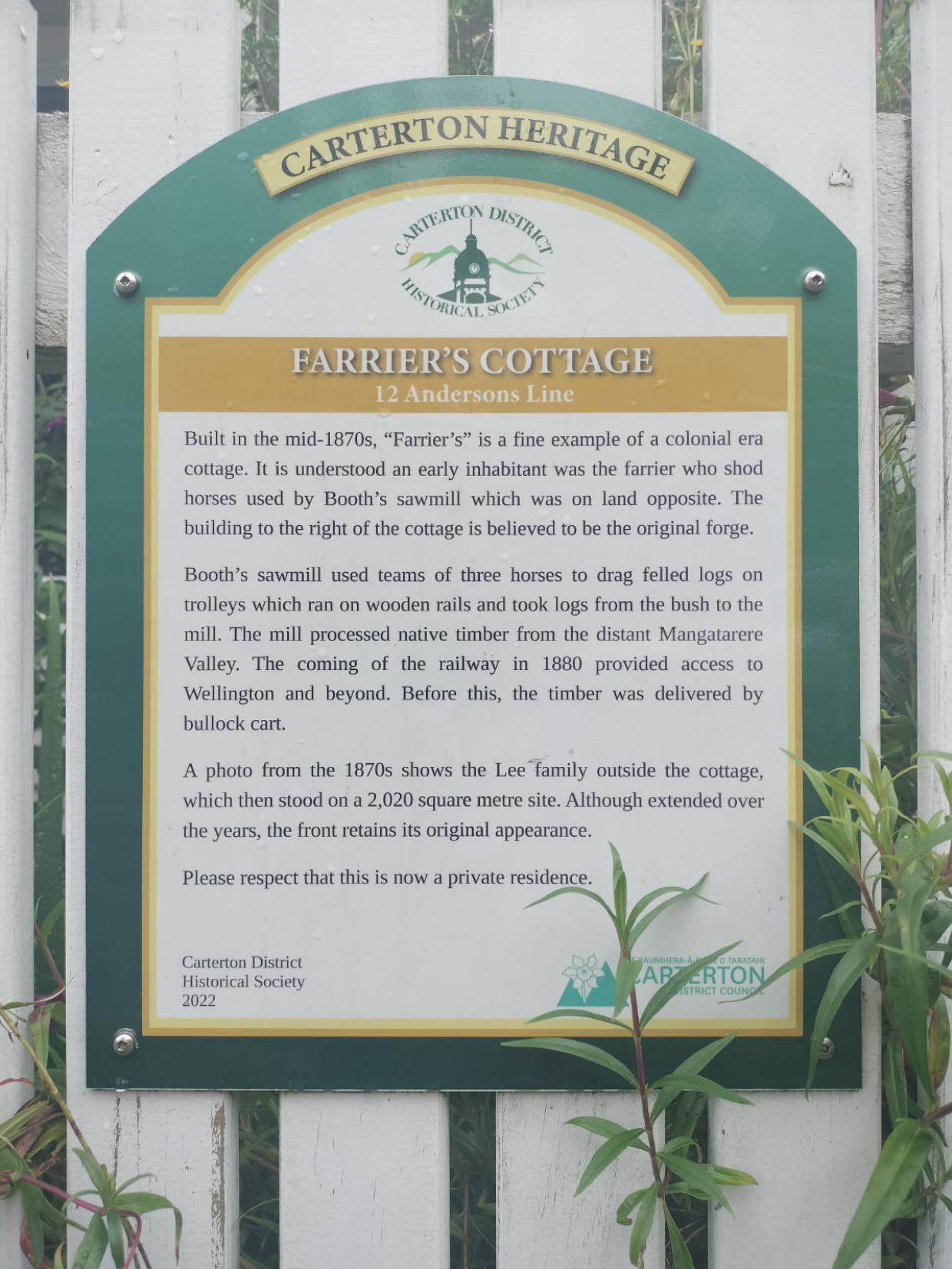The sign from the Carterton District Historical Society details some of the cottage's history.
