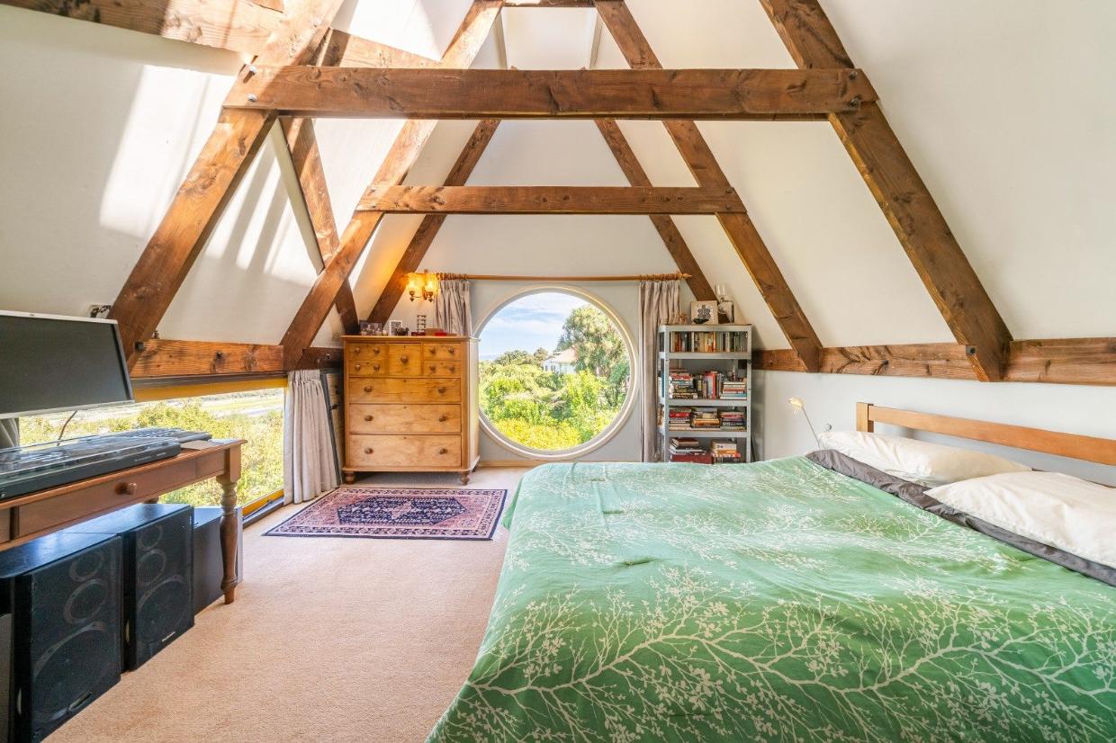 Inside the attic bedroom, one of the four bedrooms, including a window overlooking the valley