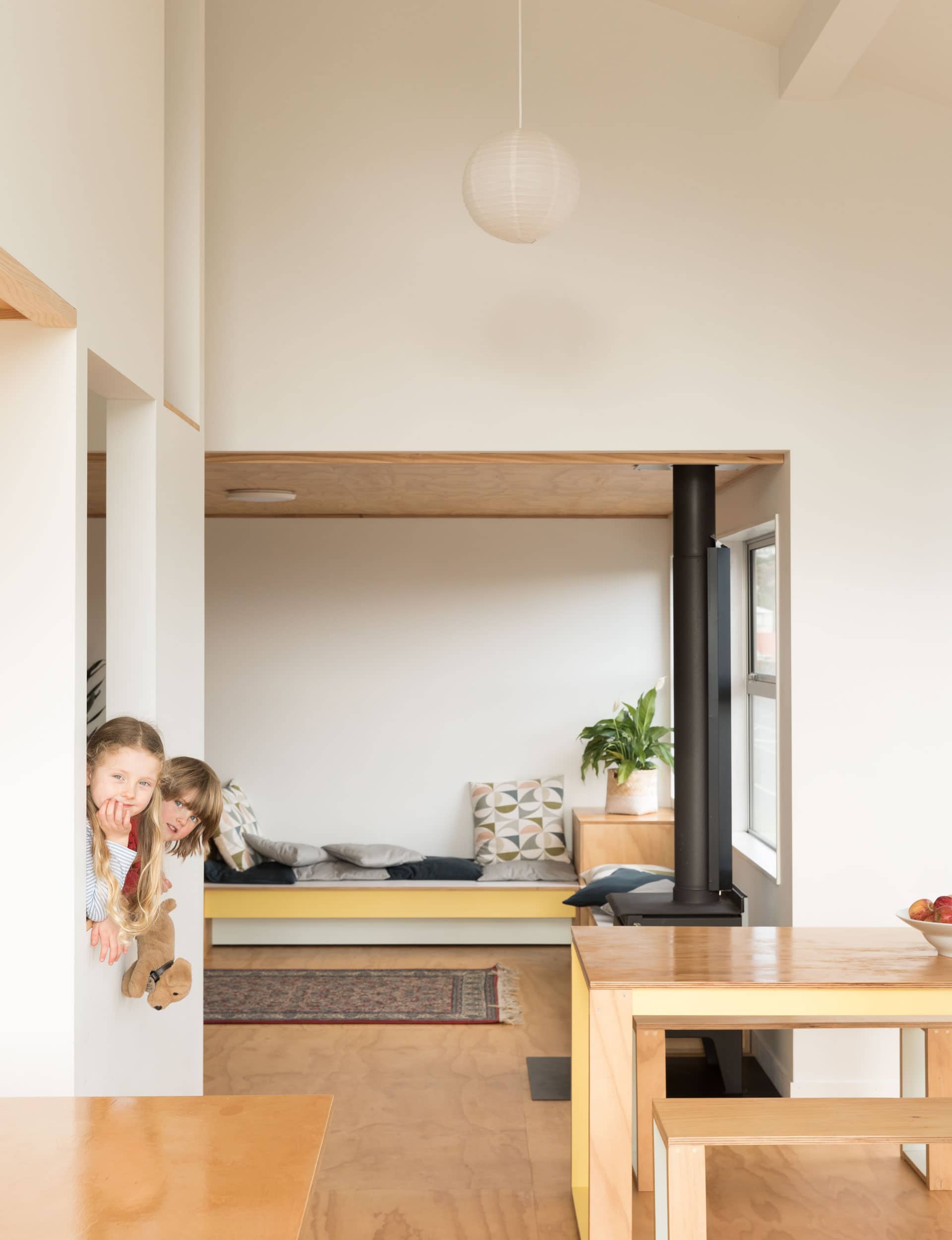 The entrance leads straight into a long, open-plan living area. There’s a built-in daybed in front of huge windows, which take in spectacular Wellington views, and an elegant steel screen that supports the stairs.