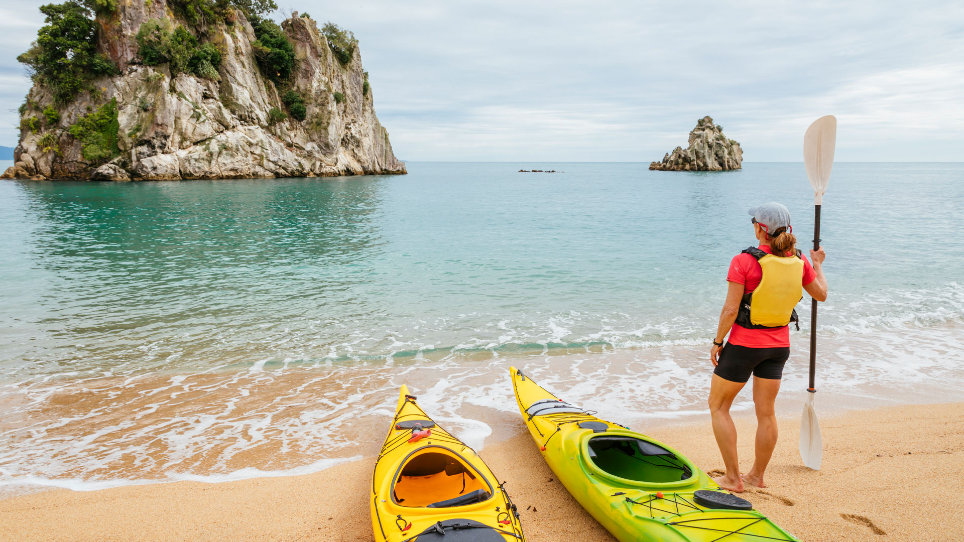 Casual tourism employee working for a kayak rental company in Abel Tasman, New Zealand.