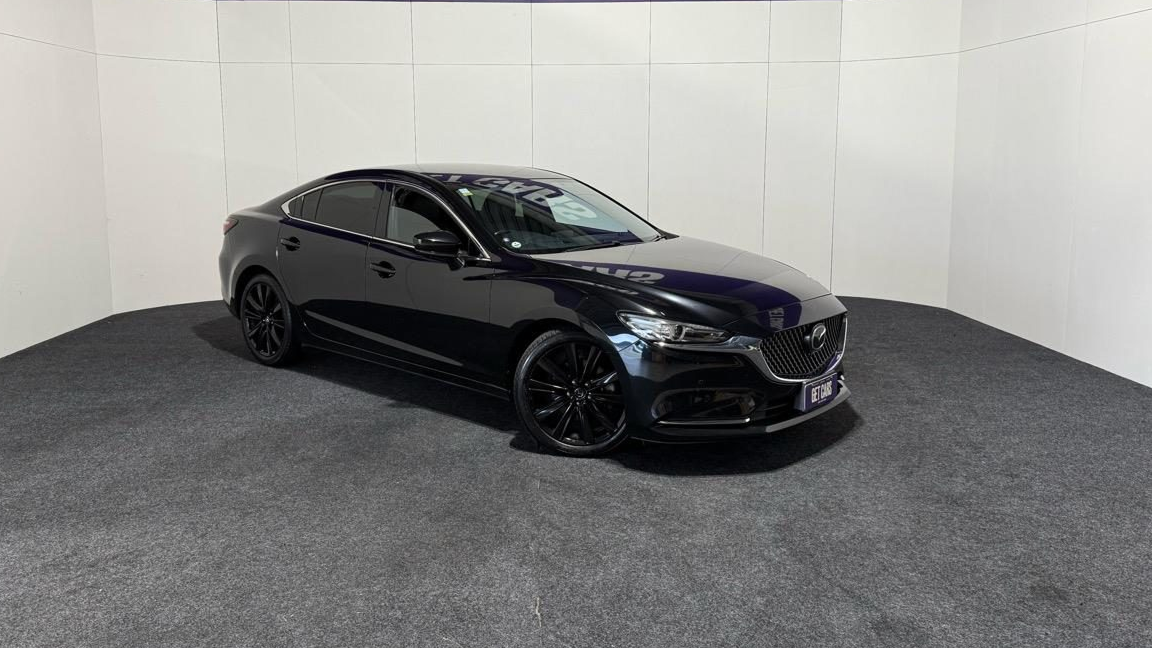 Black Mazda 6 sedan photographed in a car dealership