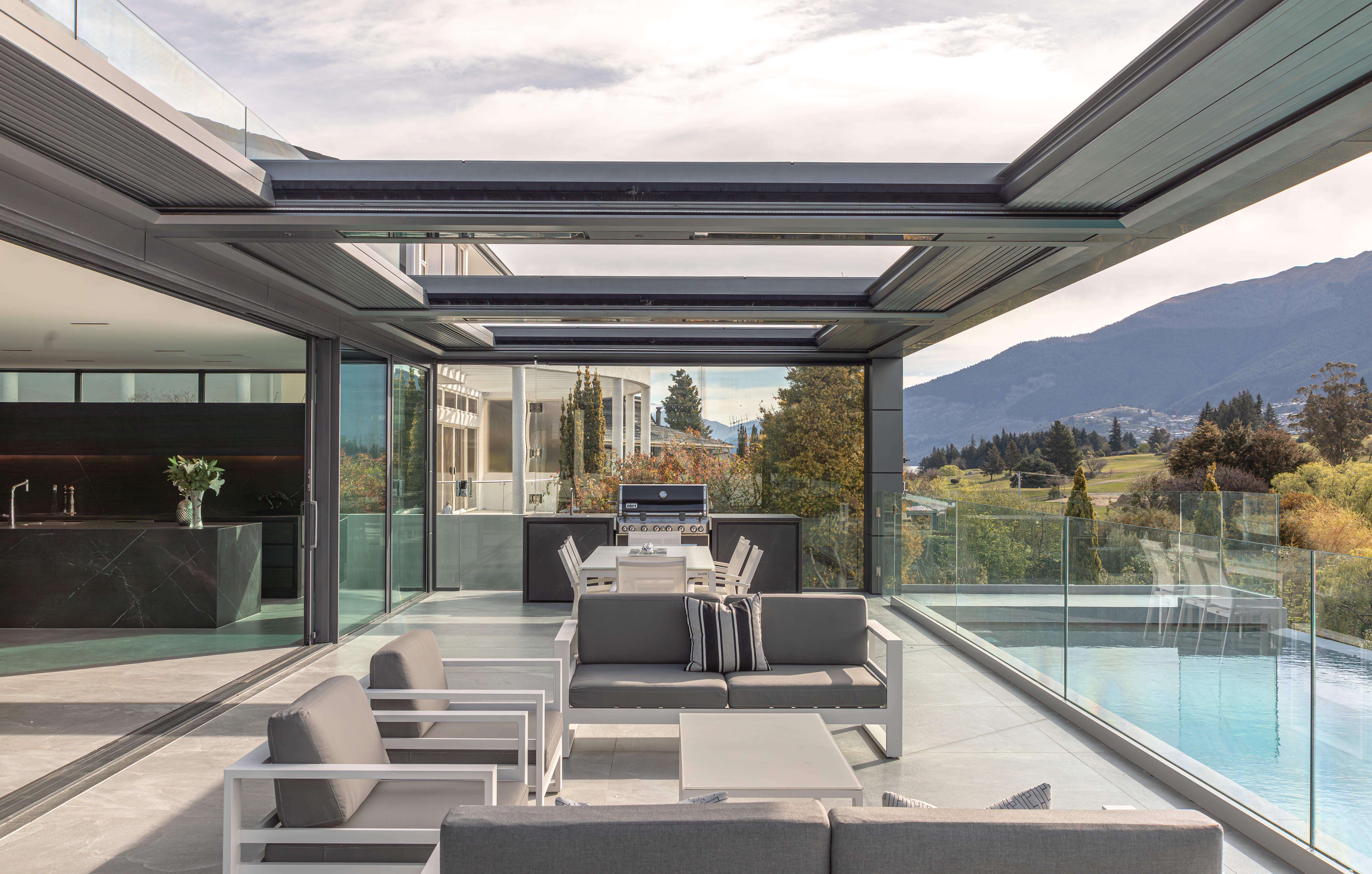 This poolside outdoor living room, designed by Gary Todd Architecture creates a seamless cohesion between indoor living space and alfresco environment with a level threshold and continuation of materials. Image: John Williams