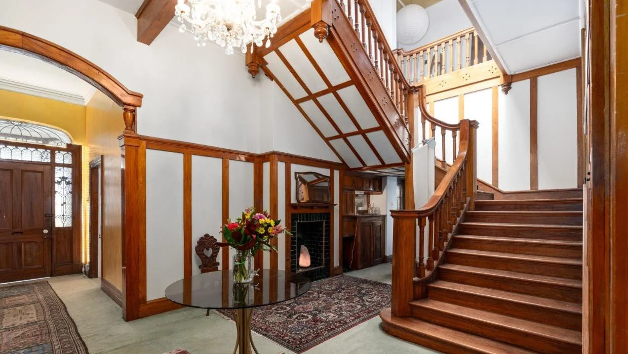 The mansion has a beautiful sweeping staircase.