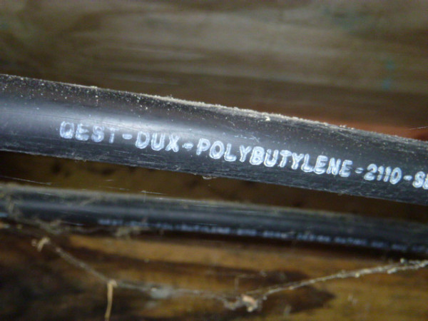 Close up shot of a black pipe with text on it.