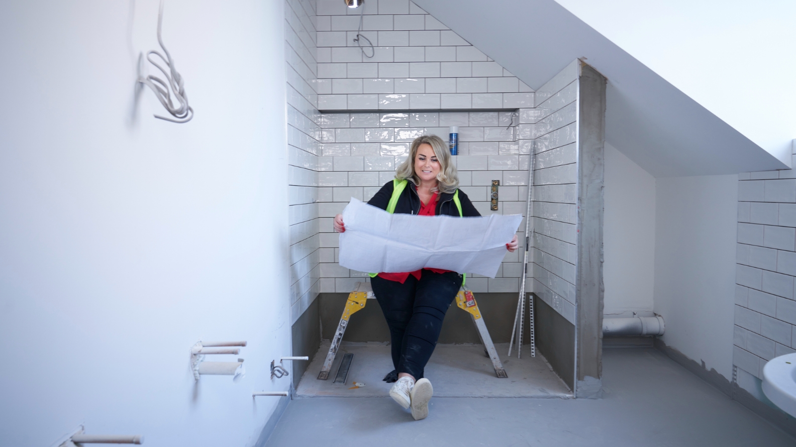 Lady looking at bathroom plans