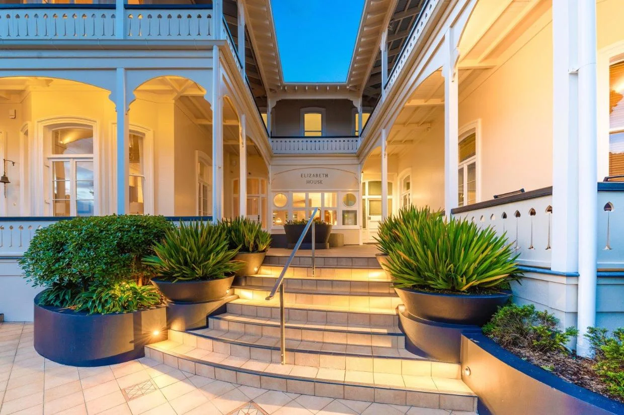 The listed apartment is at the top of the stairs to the right