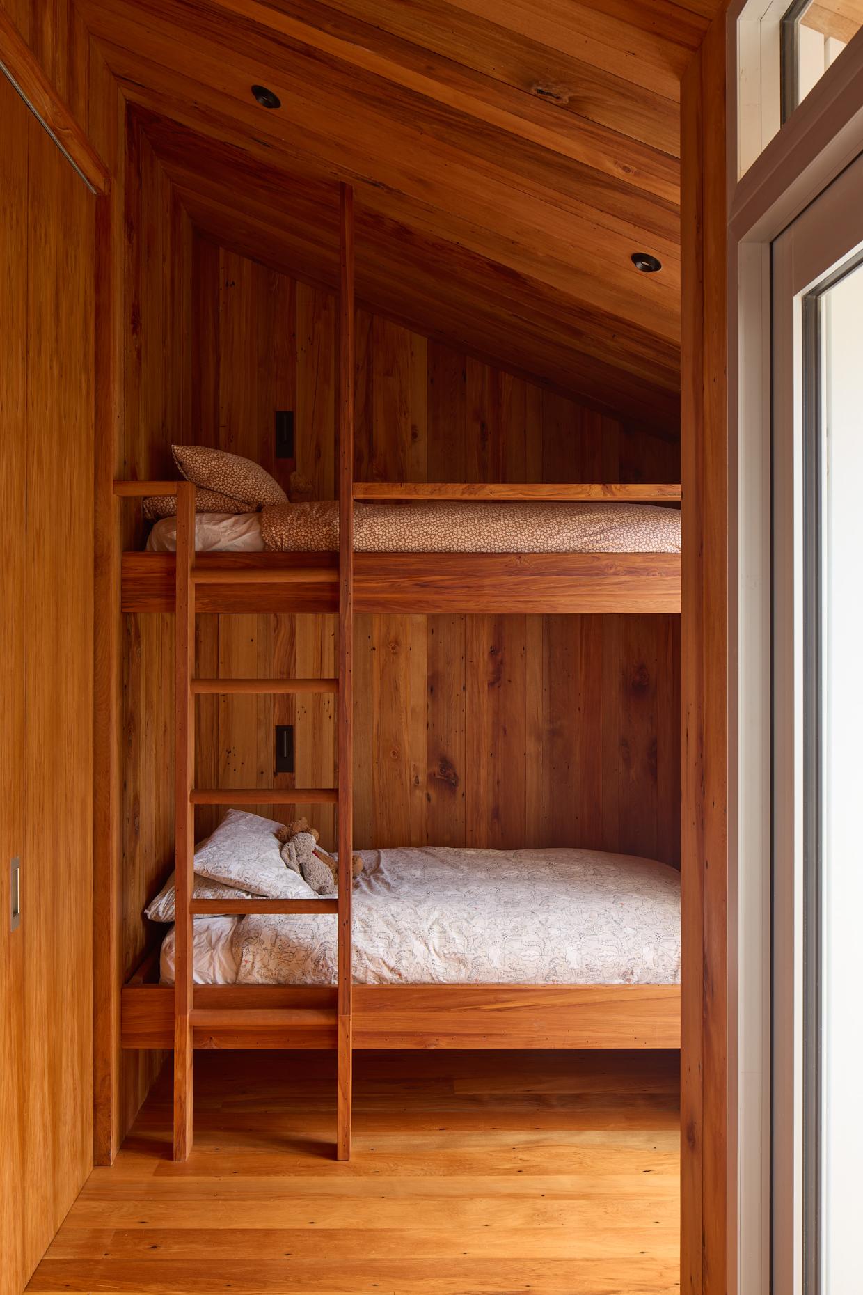 Bunk room in the sleep out with a natural oak design.