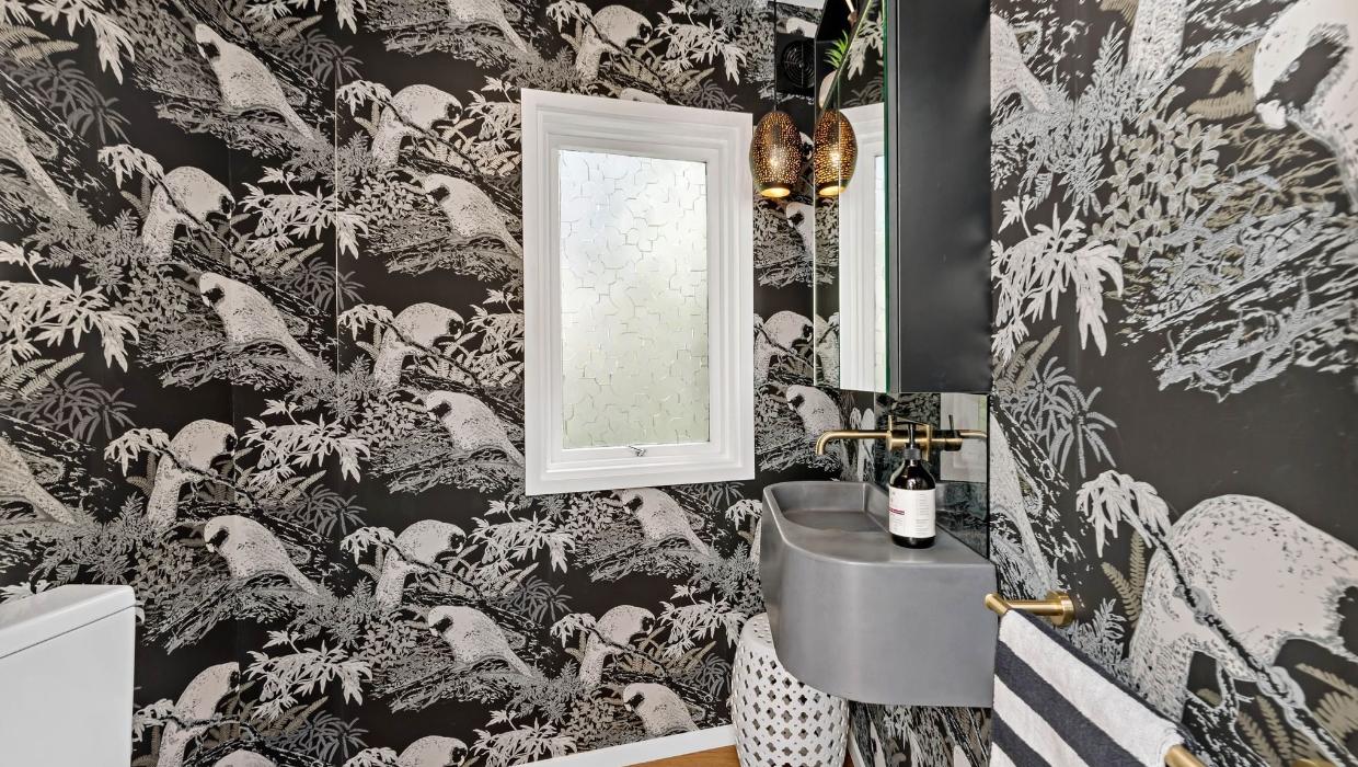 The bathrooms and this powder room have had a funky, modern update.