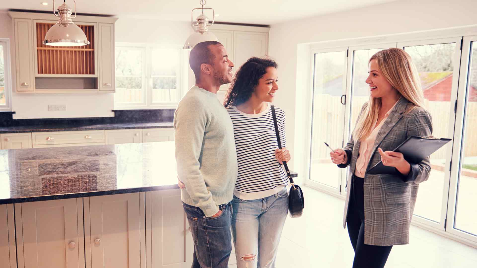 Couple asking questions to landlord when viewing a rental property.