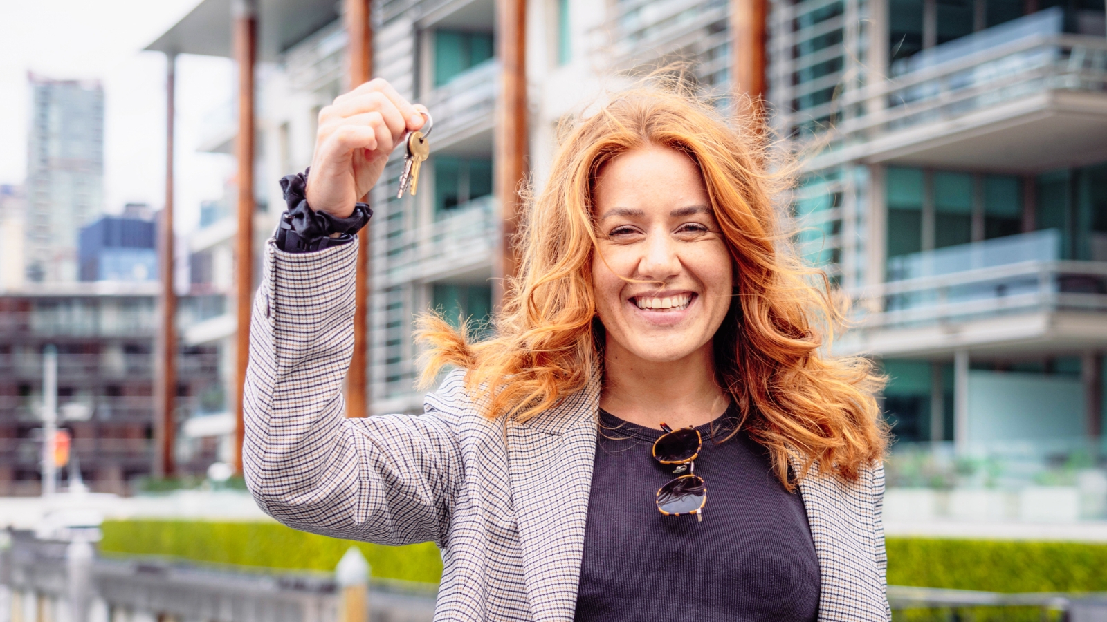 Woman holding key in Auckland's viaduct. 